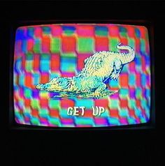 an old television with the words get up on it