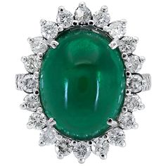 A vibrant and elegant cocktail ring perfect for an important event or gala. Features an oval cabochon emerald set in a floral motif halo made of diamonds. Made in 18k white gold. Green emerald weighs 9.00 carats. Diamonds weigh 2.00 carats and are IF clarity. Size 7 US (sizable) Dimensions: 0.91 in x 0.73 in Sapphire Emerald Ring, Wide Band Engagement Ring, Filigree Diamond Ring, White Gold Sapphire Ring, Emerald Set, Gold Sapphire Ring, Flower Halo, Emerald Diamond Ring, White Gold Sapphire