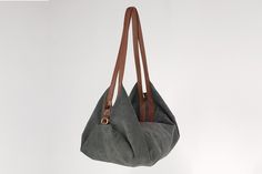 "DeLuna is a soft suede leather bag designed for women who love to carry slouchy handbags. Featured in this listing in grey suede leather, it has plenty of room for all your essentials which makes it the perfect carryall bag. The contrast of the two-tone colors on the straps and on the main body is what makes the design unique and stand out. The straps sit comfortably on your shoulder and the bag is secured with a top zipper closure. Inside the bag, there is one main compartment with a large zip Slouchy Handbags, Slouchy Hobo Bag, Leather Bag Design, Suede Purse, Hobo Purse, Women Shoulder Bag, Grey Suede, Carry All Bag, Gray Suede