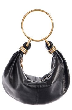 The quintessentially accessorized accessory, this grained-calfskin hobo bag takes its bracelet theme from archival Chloé designs. An adjustable crossbody strap can replace the ring top handle for another convenient way to carry the sophisticatedly slouchy style. Top zip closure Removable top ring handle; removable, adjustable crossbody strap Interior wall pocket Leather Made in Italy Designer Handbags This brand has B Corp certification, representing business practices with emphasis on social an Timeless Hobo Bag With Gold-tone Hardware, Designer Evening Hobo Bag With Detachable Handle, Gold Hobo Bag With Detachable Handle For Formal Occasions, Formal Gold Hobo Bag With Detachable Handle, Designer Shoulder Bag With Metal Hardware, Designer Shoulder Bag With Palladium Hardware, Chic Hobo Bag With Palladium Hardware For Formal Occasions, Formal Handheld Hobo Bag With Gold-tone Hardware, Chic Formal Hobo Bag With Palladium Hardware