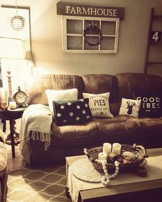 a living room filled with furniture and pillows on top of a table in front of a window