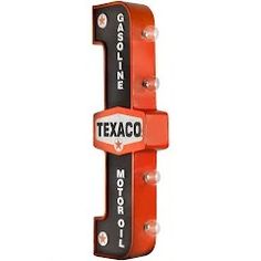 an orange and black sign that says texaco