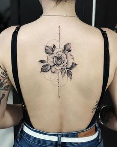 a woman's back with a rose tattoo on her upper and lower back tattoos