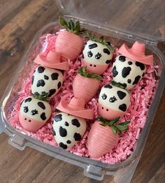 there is a plastic container filled with cake and marshmallows in the shape of cows