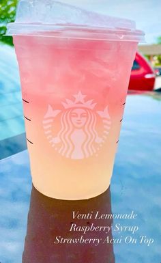 a pink drink sitting on top of a table