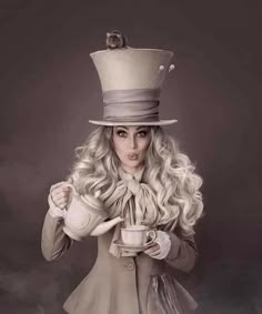 a woman in a top hat and coat holding a coffee cup