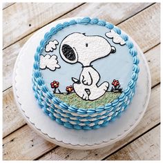 there is a cake decorated with a cartoon dog on the front and blue trimmings