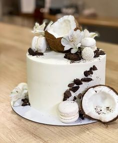 a white cake decorated with coconuts and flowers