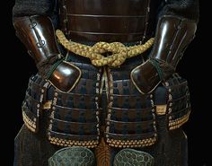 an elaborately decorated samurai armor is shown in this image, with gold accents on the chest and arms