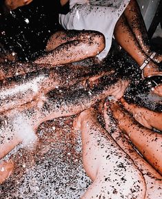 several people are covered in brown and white powdered sugar on top of each other