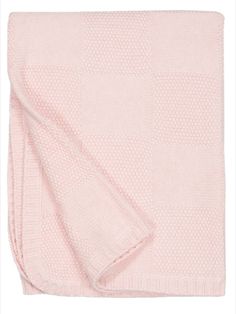 a pink blanket folded on top of a white background