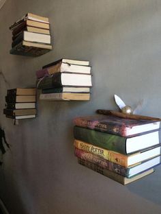 several books are stacked up on the wall next to each other and one is upside down