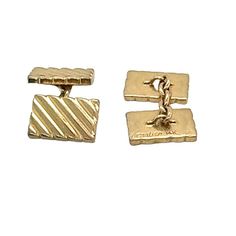 The 1950s Cartier Vintage Cufflinks are a refined and elegant accessory that embodies mid-century sophistication. Crafted by Cartier, these cufflinks feature a distinctive ribbed design in luxurious 14 karat yellow gold, offering a timeless and polished look. Perfect for adding a touch of vintage charm to any formal ensemble, they exemplify Cartier's renowned craftsmanship and enduring style. The rectangular cuff measures 10 x 15mm. Signed Cartier. Weight: 15.7 grams.     4o Cartier Rectangular Business Jewelry, Classic Cartier Jewelry For Formal Occasions, Vintage Cartier Rectangular Jewelry, Antique Business Cufflinks With Polished Finish, Antique Cufflinks With Polished Finish For Business, Antique Cufflinks With Polished Finish, Cartier Rectangular Jewelry With Polished Finish, Vintage Formal Cufflinks With Polished Finish, Vintage Polished Cufflinks For Formal Occasions