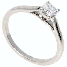 a white gold engagement ring with a single diamond in the center, on a white background