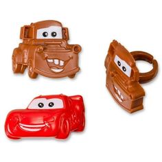 three toy cars with faces on them sitting next to each other