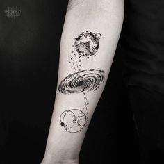 a person with a black and white tattoo on their arm that has an image of the planets