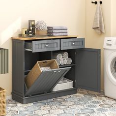 a washer and dryer sitting next to each other in a room with tile flooring