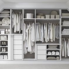 a white closet filled with lots of clothes