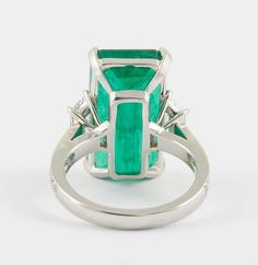 an emerald and diamond ring set in white gold