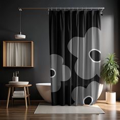 a bathroom with a black and white shower curtain in the shape of an abstract design