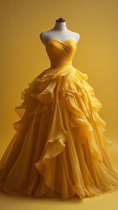 A stunning yellow ball gown displayed on a mannequin. The dress is intricately designed with layers of flowing fabric, creating a voluminous and elegant look.    #fashion #fashionista #fashionable #womenswear #womensstyle #prom #weddingdress #weddingcollection #ballgown #yellow #womenclothing #fashiongoals #fashioninspiration #gown #promdresseslong Prom Fairytale Theme Dress, Mustard Yellow Wedding Dress, Dark Yellow Prom Dress, Yellow Ball Dress, Autumn Gown, Belle Prom Dress, Fantasy Ballgown, Wedding Dress Yellow, Yellow Gowns