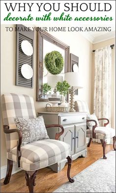 a living room with two chairs and a mirror on the wall over a dresser in front of a window