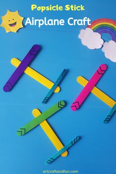 popsicle stick airplane craft on a blue background with clouds and rainbows in the sky