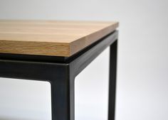 a wooden table sitting on top of a metal frame