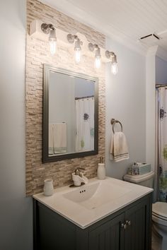 a bathroom with a sink, toilet and shower in it's center piece is shown