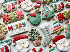 decorated christmas cookies are displayed on a table