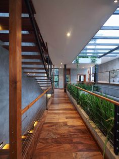 the inside of a modern house with wood floors and glass railings on both sides