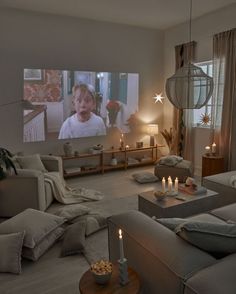 a living room filled with furniture and a flat screen tv mounted to the side of a wall