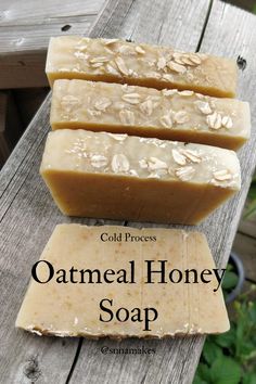 three bars of oatmeal honey soap sitting on top of a wooden table