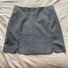 Soft Mini Skirt With 2 Slits. Black And White Small Checkered Plaid Pattern. With Stretch In The Back Waist. Never Worn. Back Zipper. Black Split Hem Skirt For Summer, Trendy Fitted Skirt With Split Hem, Fitted Trendy Skirt With Split Hem, Black Pencil Skirt With Split Design, Black Split Hem Skirt For Spring, Summer Split Hem Lined Skirt, Trendy Black Split Bottoms, Black Fitted Skirt With Split Hem, Chic Black Skirt With Split Hem