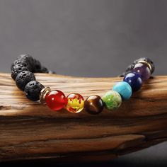 The average person's Chakras are unbalanced. In a healthy, balanced individual, the seven Chakras provide exactly the right amount of energy to every part of the body, mind and spirit. Benefit from the healing properties of this stunning hand-made lava stone bracelet, boosting energy and awareness, while reducing stress and anxiety . This gorgeous bracelet is created with seven different high quality natural stone beads. Each one of the seven chakras is represented by one unique stone: Amethyst 7 Chakra Bracelet, The Seven Chakras, Chakra Racine, Lava Stone Bracelet, Seven Chakras, Natural Stone Beads, Yoga Bracelet, Les Chakras, 7 Chakra