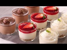 small desserts with strawberries and whipped cream are arranged in individual cups on a table