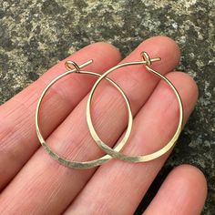 These Hammered Gold Hoop Earrings are handmade in my little studio. They feature a subtle hammered edge and shiny finish. The 14k Gold Filled Hoops are 1mm thick, and sit comfortably in the ear. Each pair is around 26mm wide. Your earrings will be delivered in a recycled, branded jewellery box ready for gifting. Delivery These hammered earrings are ready to be shipped.  See other earrings in my shop here https://www.etsy.com/uk/shop/MineralsRockStudio -What is gold filled?- Gold filled is a proc Branded Jewellery, Handmade Hoop Earrings, Hammered Earrings, Gold Filled Hoops, Hammered Gold, Handmade Gold, Gold Hoops, Gold Filled Jewelry, Jewelry Earrings Hoops