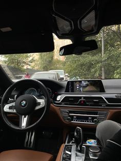 the interior of a bmw car with an entertainment system and steering wheel view from inside