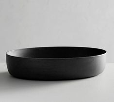 a black bowl sitting on top of a white table