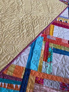 a close up view of a colorful quilt