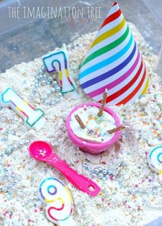 a birthday cake with candles and decorations in the sand for an age nine year old