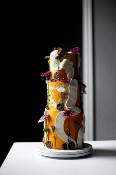 a three tiered cake with flowers on it