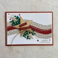 a christmas card with an ornament and ribbon