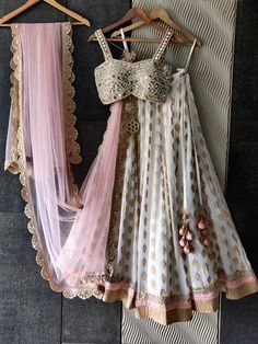 Ivory butti georgette lehenga with a ruffle shimmer and blush pink border is paired with our signature mirror and pearl hand embroidered bustier. Completed with a blush pink sequenced butti work dupatta with a scallop border. Transitional Floor-length Choli With Gota Work, Wedding Choli With Gota Work For Navratri, Wedding Saree Set With Gota Work, Traditional Drape Sets With Gota Work For Wedding, Wedding Sets With Gota Work And Traditional Drape, White Art Silk Choli For Wedding, White Kundan Lehenga For Party, Fitted Lehenga With Gota Work For Wedding, Fitted White Kundan Choli