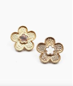 Post Back Closure Textured Gold Metal Flower with Mother of Pearl Center Light up your look with these stunning studs! These earrings feature a textured gold metal flower with a mother of pearl center, giving you a fun and unique way to add some sparkle to any outfit. Whether you're dressing up for a night out or just looking to make a statement, these clover stud earrings are sure to give you the perfect touch of whimsy and fun! 0.75W" x 0.75H" Trendy Gold Flower Charm Earrings, Chic Metal Flower Earrings, Trendy Gold Flower Earrings, Gold Flower Earrings For Spring, Spring Rose Gold Metal Flower Earrings, Spring Rose Gold Flower Metal Earrings, Gold Earrings With 3d Flowers For Spring, Chic Gold Flower Earrings, Gold Chic Flower Earrings