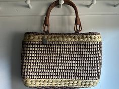 "Top handle handbag in Beige and Brown Colors by SAK This SAK basket Handbage has a fabric lining that closes with a zipper, and a small inside pockets. It has adorable brown handles, so fun for a summer day or evening. The handbag size is 16\"Lx2\"Wx10\"T. Great everyday Bag for the beach. Clean. In good condition." Summer Light Brown Bag With Braided Handles, Brown Beach Bag With Rolled Handles For Shopping, Brown Woven Straw Basket Bag, Brown Straw Bag With Rolled Handles, Brown Basket Straw Bag For Daily Use, Casual Brown Beach Bag With Rolled Handles, Brown Double Handle Straw Bag With Rolled Handles, Daily Use Brown Basket Straw Bag, Brown Basket Beach Bag With Rolled Handles