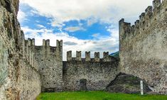 an old stone castle with grass in the foreground