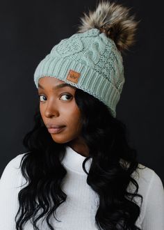 Light blue cable knit hat Natural faux fur pom accent Fleece lined Crown patch on the left side One size 100% Acrylic Knitted Hats Kids, Knit Hat For Men, Knit Jewelry, Cable Knit Hat, Blouse Tank Top, Pom Pom Hat, Knitting For Kids, Men's Knit, Fur Pom Pom