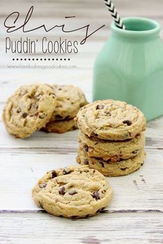 chocolate chip cookies are stacked on top of each other in front of a blue vase