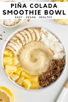 a bowl filled with bananas and granola on top of a white table next to sliced lemons